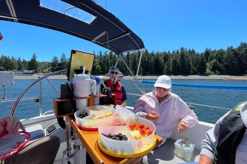 A boat with a table set for a meal, surrounded by water and trees. 3