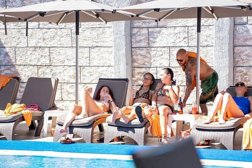 A poolside with lounge chairs and umbrellas. 2
