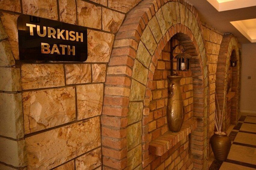 A Turkish bath with stone walls and arched niches. 3