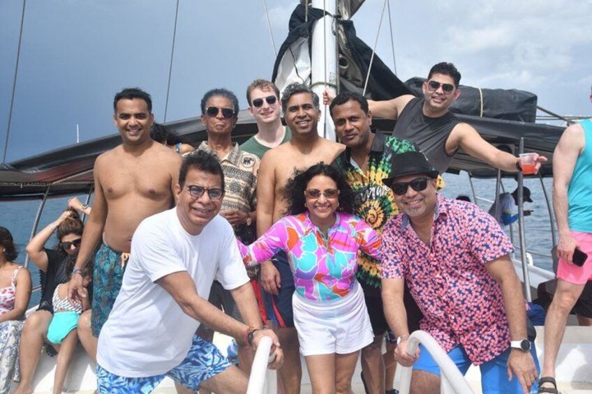 A group of people on a sailboat with a clear sky. 3