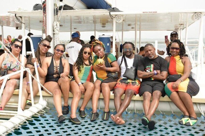 A group of people sitting on a boat deck. 3