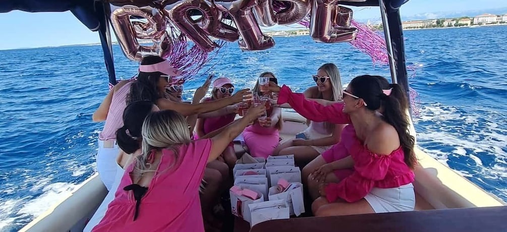 A group of people on a boat, toasting with drinks, with 'BRIDE' balloons above them. 5