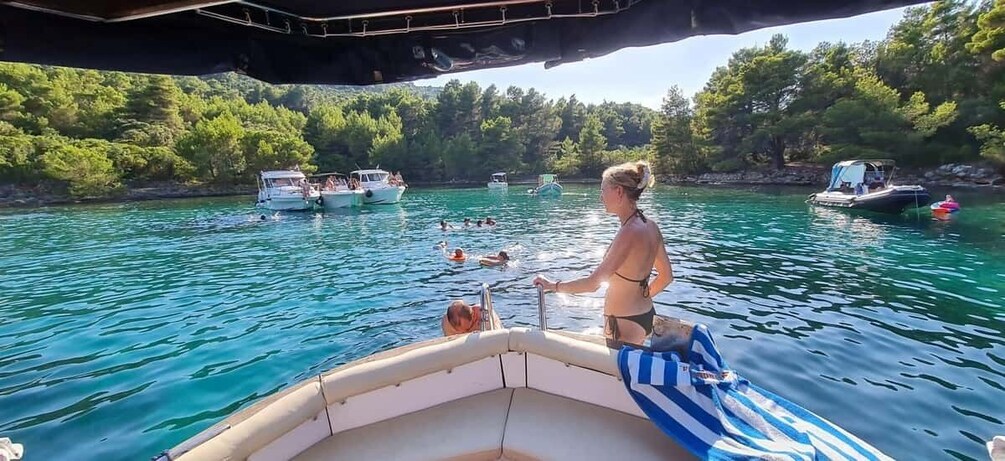 A boat on a turquoise lake surrounded by trees. 2