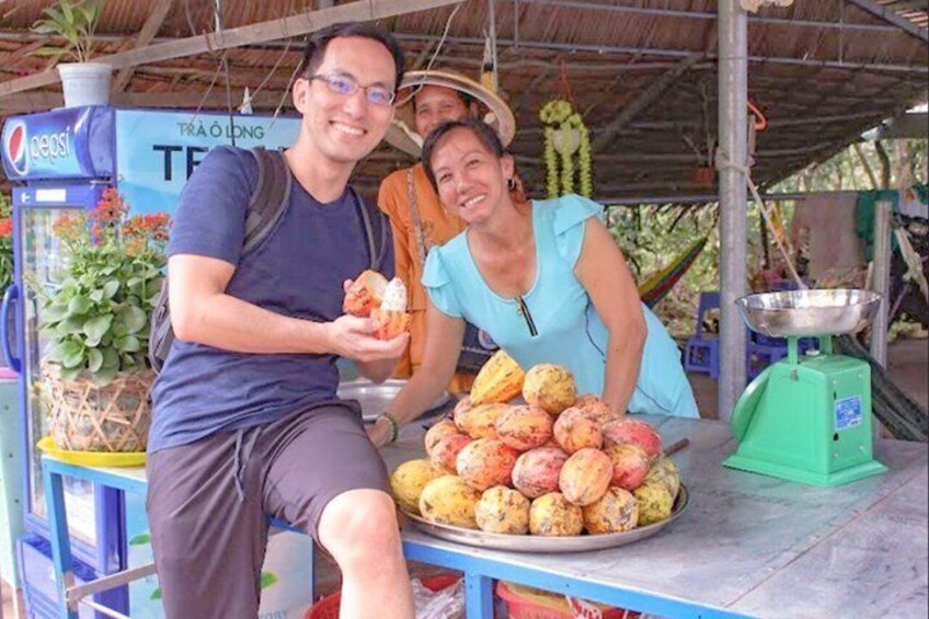 A man and a woman at a food stall with a Pepsi refrigerator and a weighing scale. 3