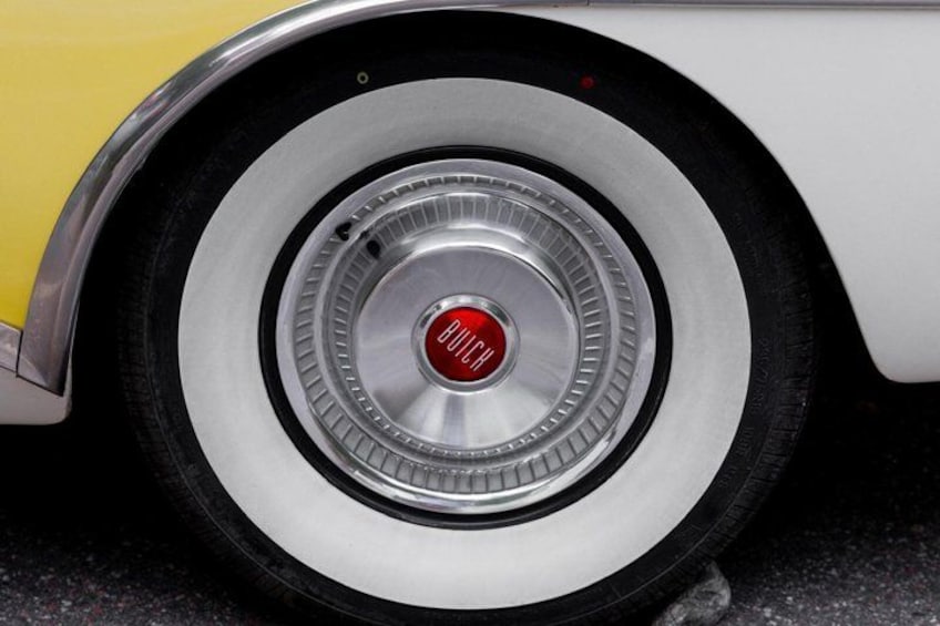 A close-up of a car's wheel with a red 'BUCH' logo. 4