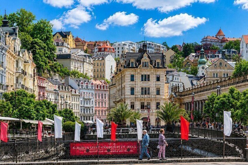 A historic cityscape with a prominent building labeled 'KARLOVVENSCHTADT' and a red banner. 2