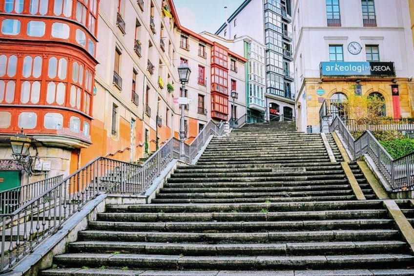 A set of stone steps leading up to a building with a sign that reads 'Arkeologi Museo.' 4