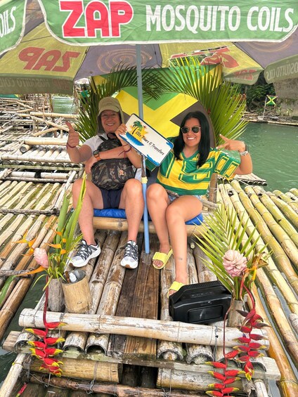 Two people on a bamboo raft with mosquito coil advertisements, surrounded by water. 4