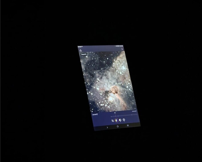 A smartphone displaying a starry night sky with a visible galaxy. 4