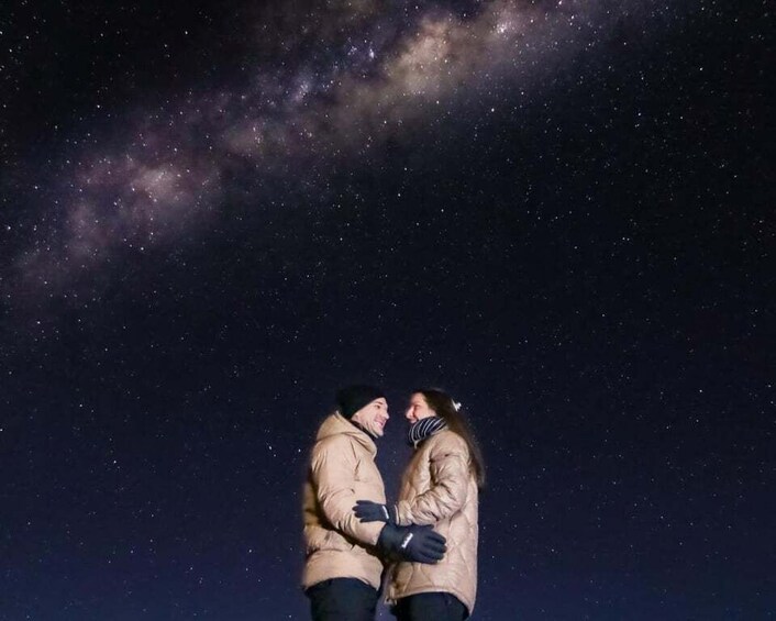 Two people embracing under a starry night sky. 5