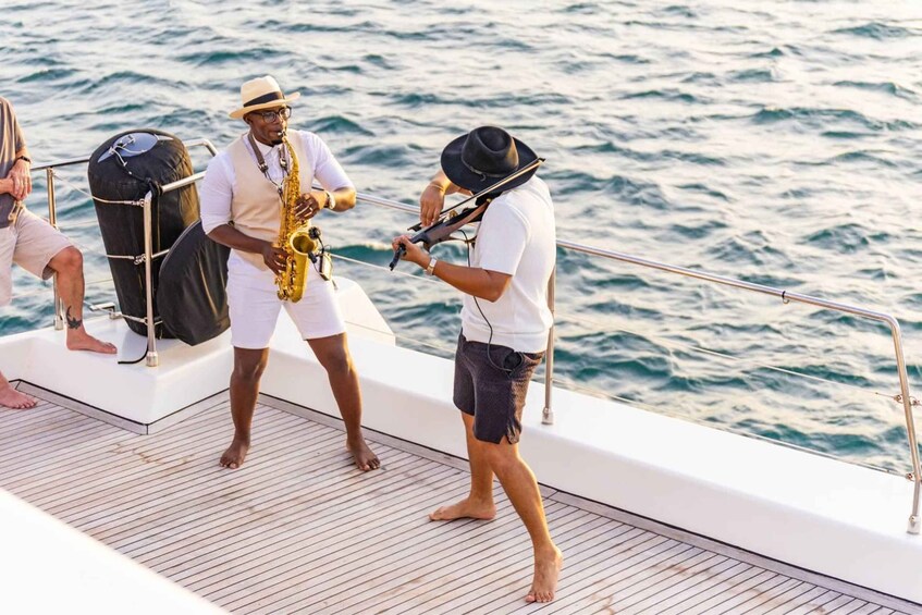 Musicians on a boat deck with a saxophonist and a violinist. 4