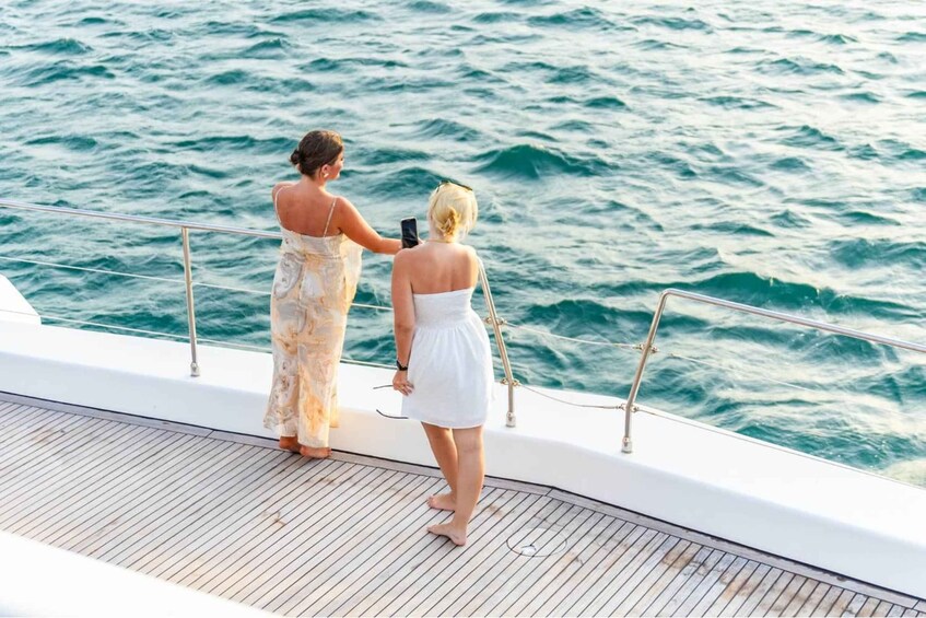 Two people on a boat deck with the ocean in the background. 2