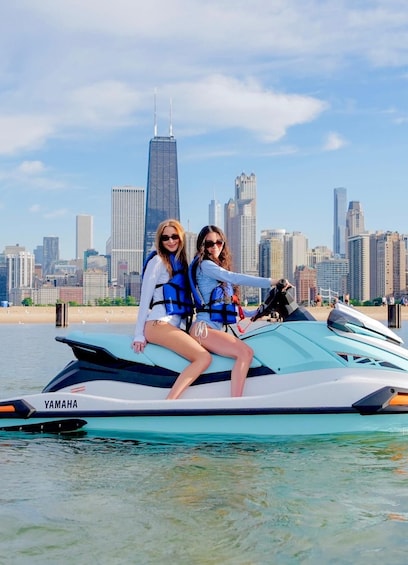 Two people on a Yamaha jet ski with a city skyline in the background. 3