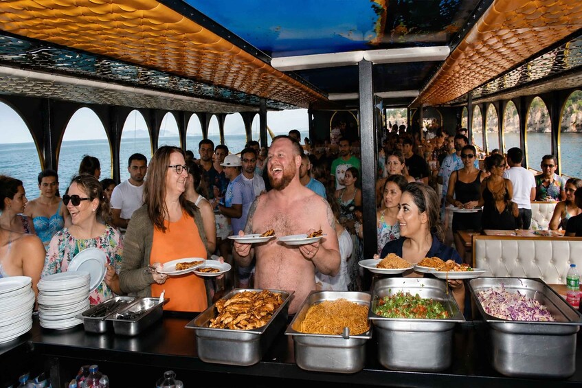 A buffet with various food options and a crowd of people. 5