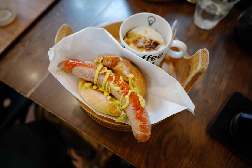 A hot dog with mustard and relish in a bun, served on a paper tray. 5