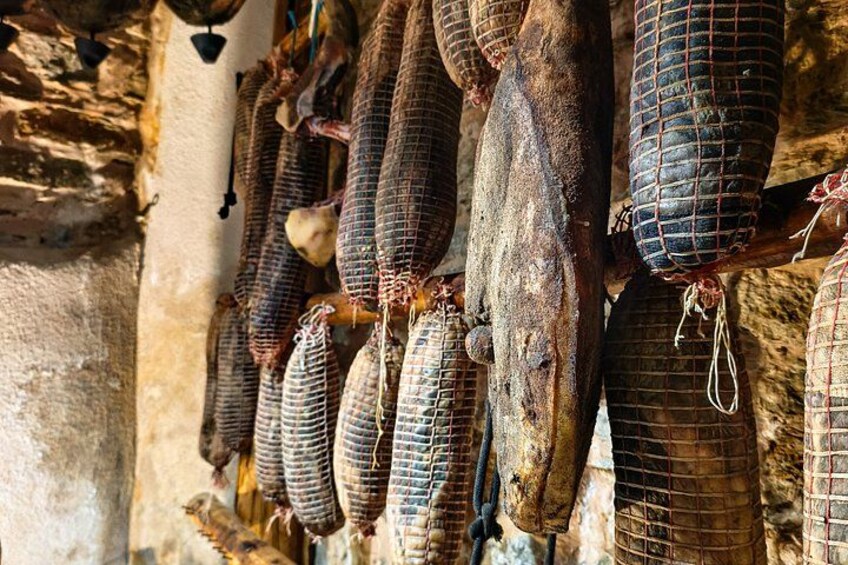 Hanging cured meats in a rustic setting. 2