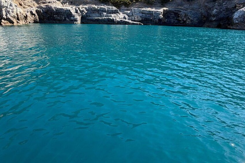 A turquoise sea with rocky cliffs. 2