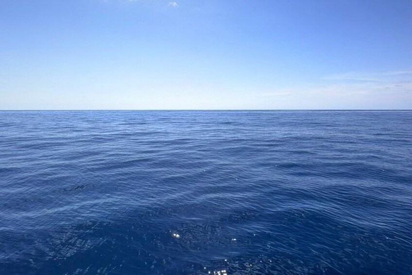 A vast expanse of ocean under a clear sky. 1