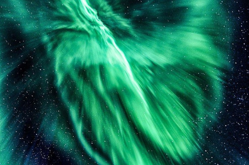 A green aurora borealis over a starry night sky. 2