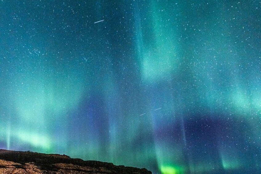 The Northern Lights over a rocky landscape. 4