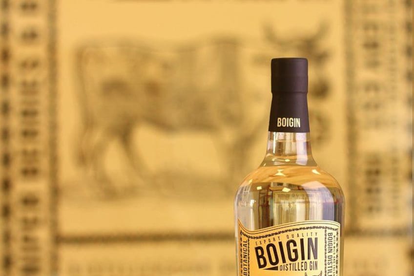 A bottle of Boigin distilled gin with a label and a bull illustration in the background. 3