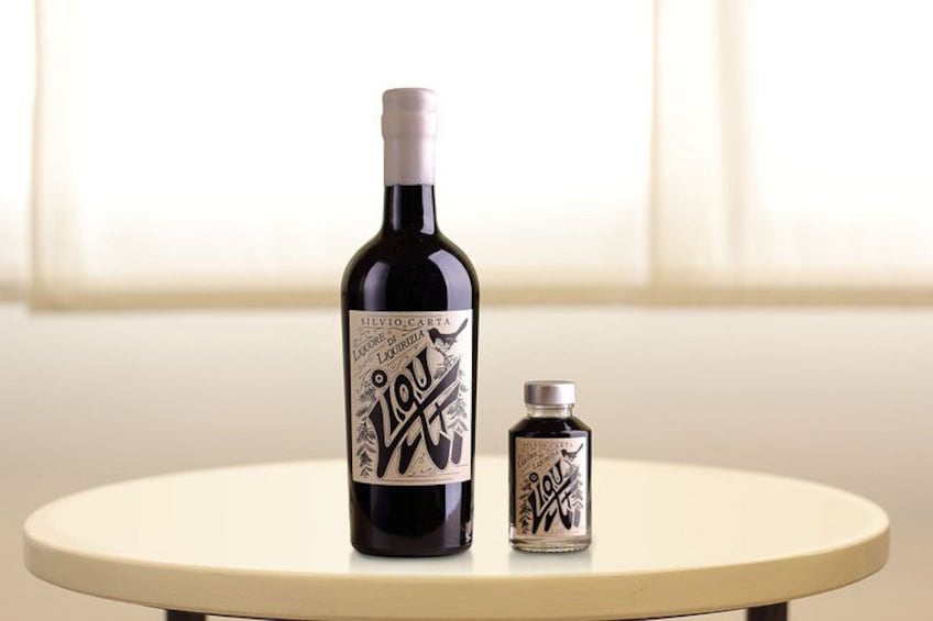 A bottle of liquor and a smaller bottle on a round table. 2