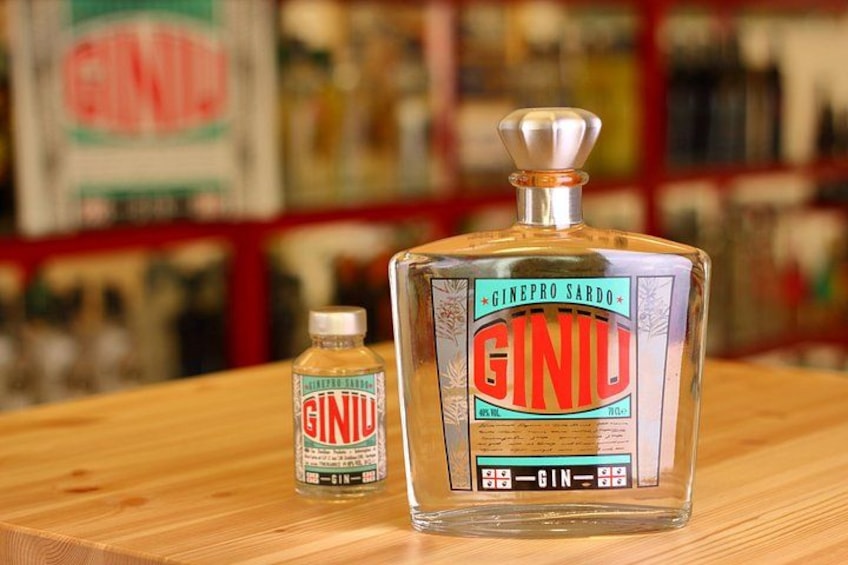 A large bottle of gin and a smaller bottle of gin liqueur on a wooden table. 4