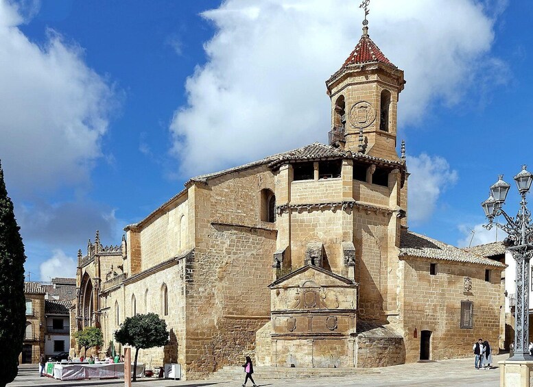 A historic church with a bell tower and a clear blue sky. 1
