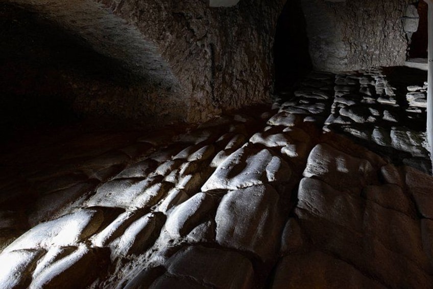 A stone floor with a pattern of irregularly shaped stones. 4