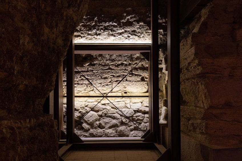 A stone wall with a glass window. 2