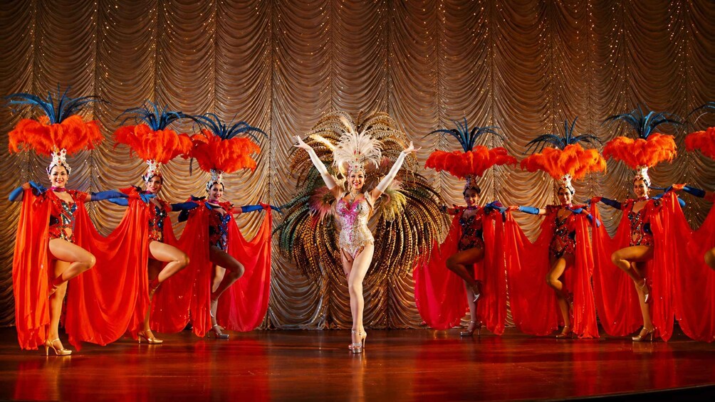 A stage with performers in vibrant costumes and feathered headdresses. 5