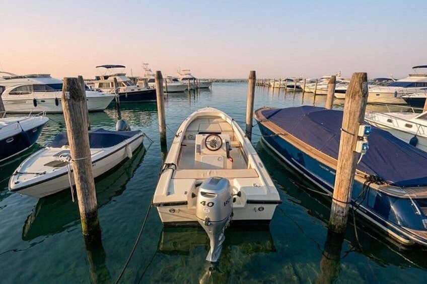 A marina with various boats docked at wooden piers. 4