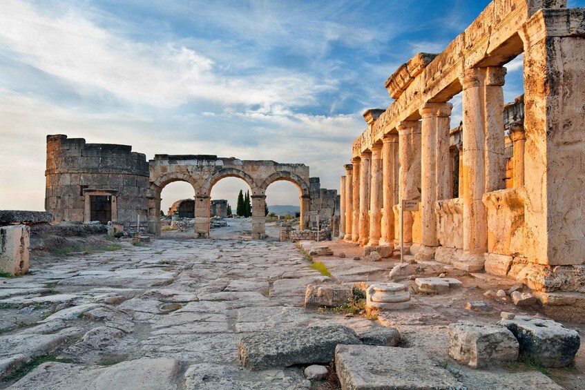 Ancient ruins with stone columns and arches. 4