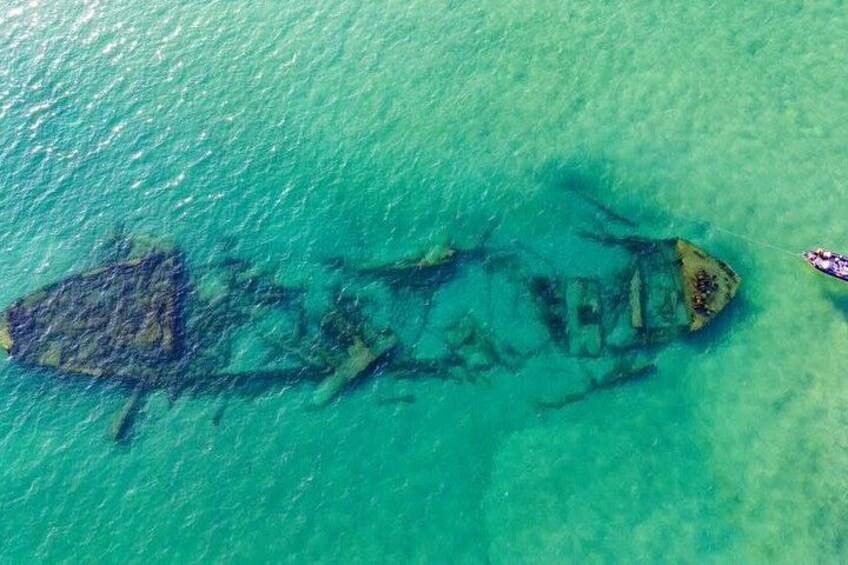 An underwater wreckage in clear turquoise water. 2
