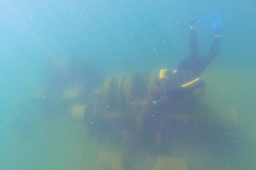 A diver underwater, possibly exploring or inspecting a submerged structure. 3