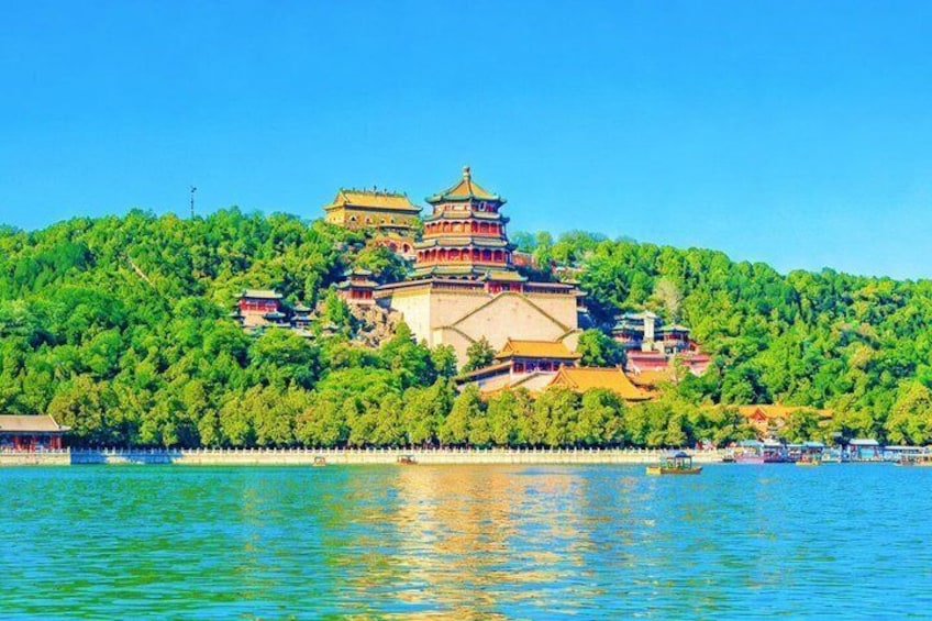 A traditional Chinese pagoda on a hill with a lake in the foreground. 4