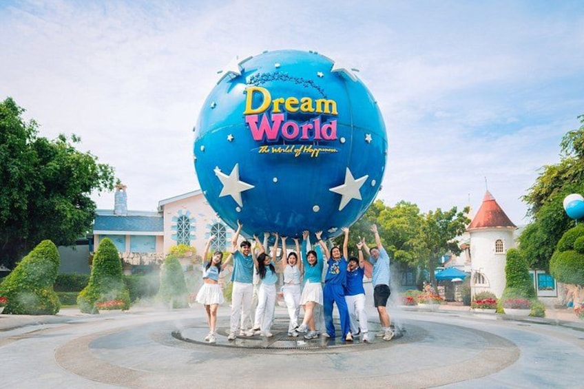 A large blue globe with 'Dream World' text, surrounded by people, trees, and a water feature. 1