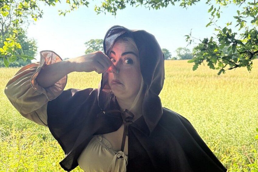 A person in a field with trees in the background. 1