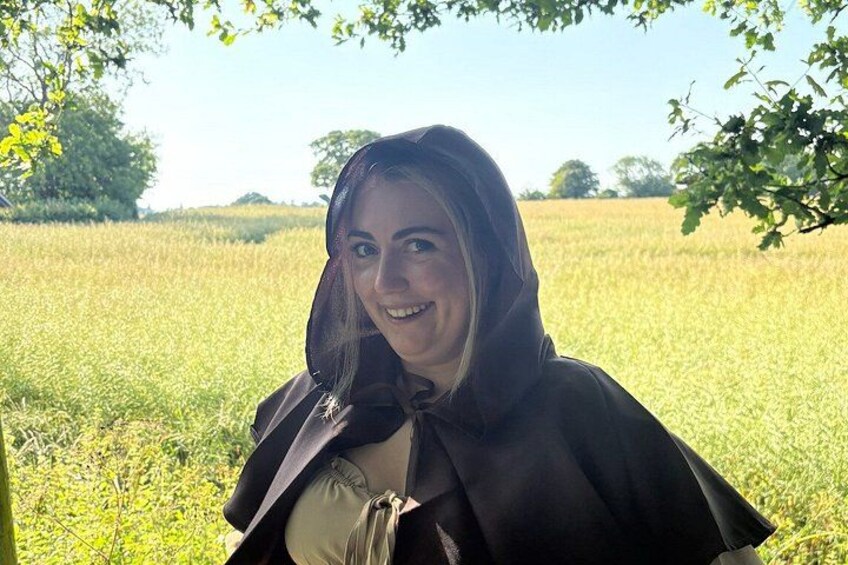 A person standing in a field with trees in the background. 3