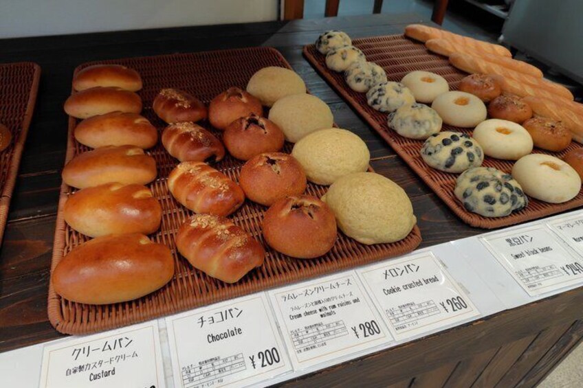 A display of various baked goods with labels indicating names and prices. 5