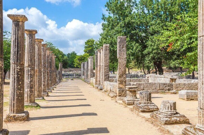 Ancient stone columns lining a pathway in a historical site. 2