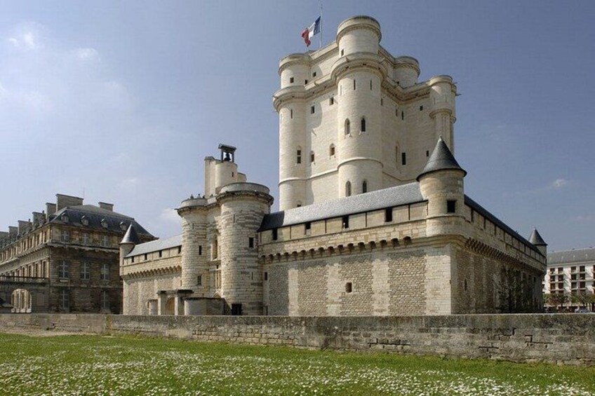 A large, historic castle with multiple towers and a flag on top. 1