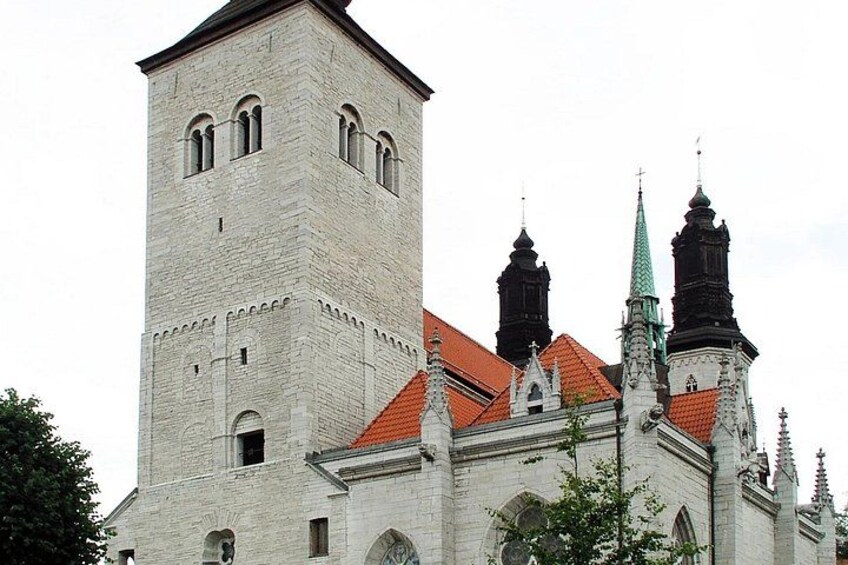 A historic building with a prominent tower and multiple spires. 5
