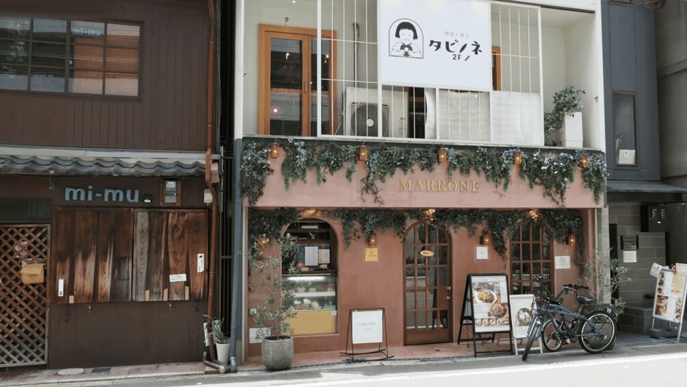 A storefront with a sign reading 'MARRONE' and a bicycle parked outside. 4