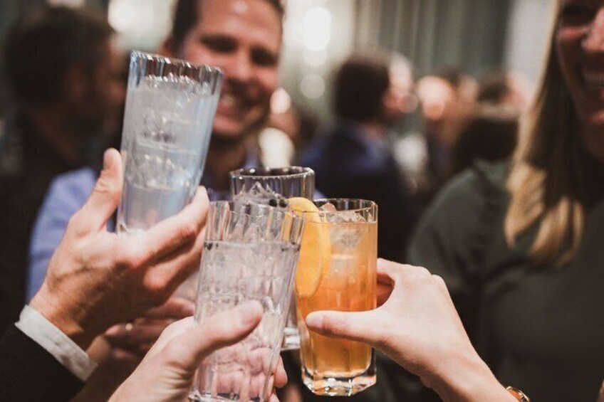 People holding glasses of beverages. 3