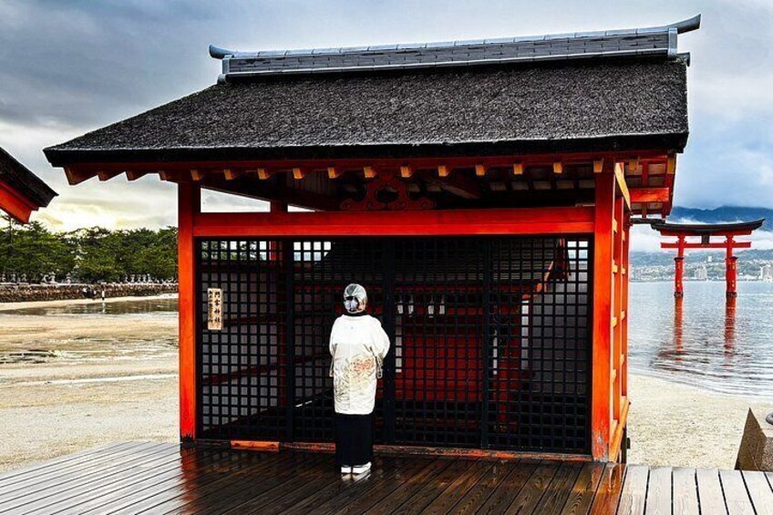 A traditional Japanese torii gate with a person standing in front of it. 5