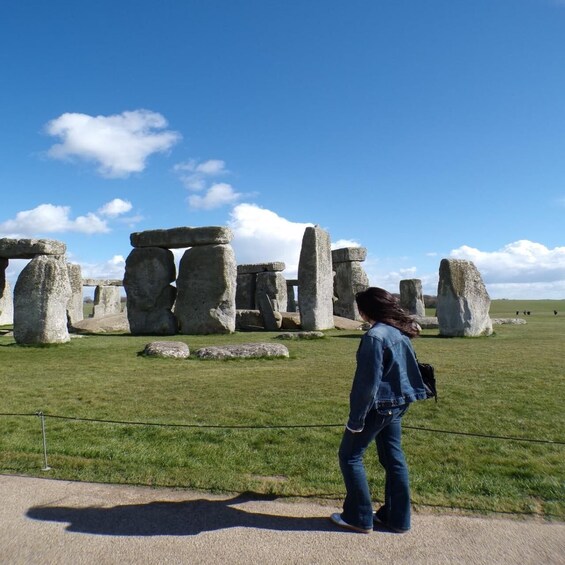 Stonehenge with a person walking in the foreground. 5