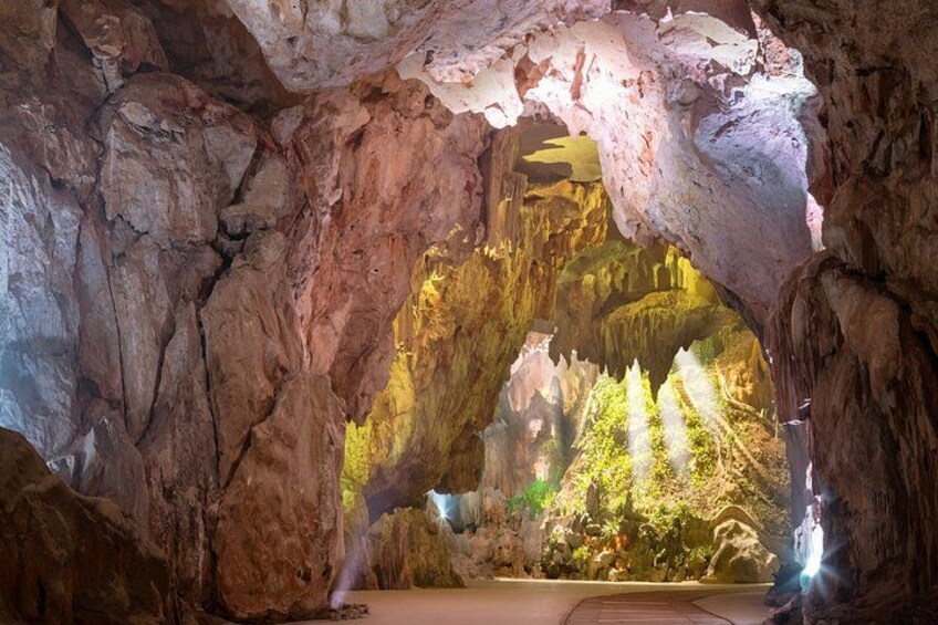 A cave with stalactites and stalagmites, a water feature, and a pathway. 4