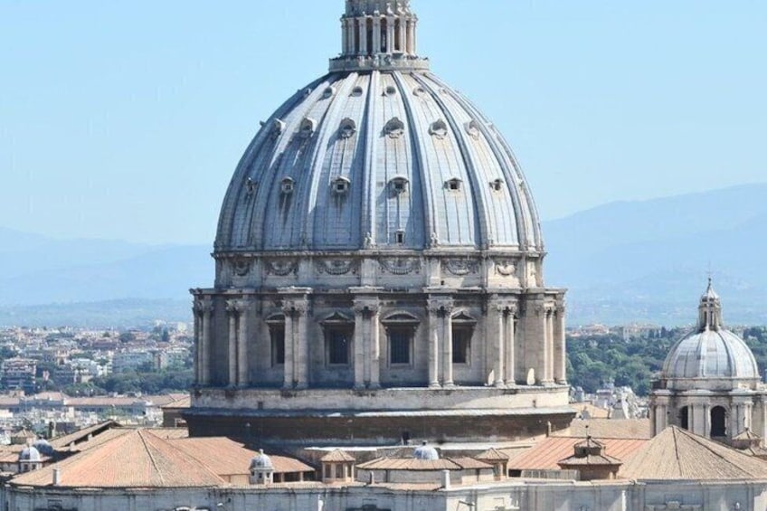 A large dome structure with a clear sky and distant mountains. 2