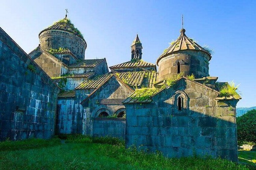 A historic church with domed roofs and a bell tower. 2